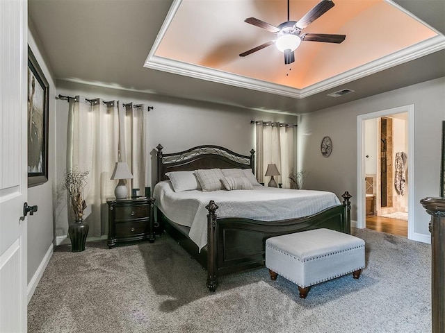 15508 Homecoming Dr, Edmond, OK 73013 - bedroom with carpet floors, a raised ceiling, baseboards, ensuite bath, and ceiling fan