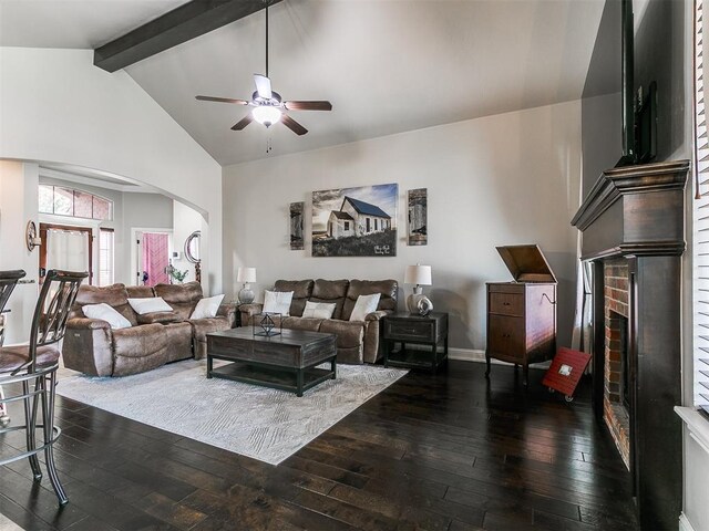15508 Homecoming Dr, Edmond, OK 73013 - living area with ceiling fan, dark wood-style floors, arched walkways, and a brick fireplace
