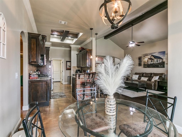 15508 Homecoming Dr, Edmond, OK 73013 - dining area featuring arched walkways, ceiling fan, tile patterned floors, beamed ceiling, and baseboards