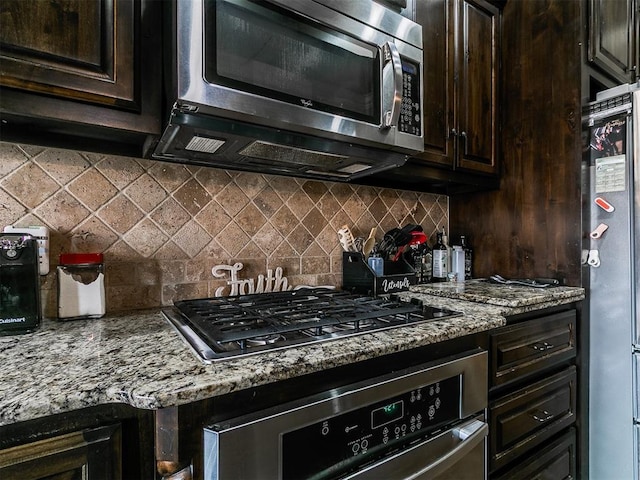 15508 Homecoming Dr, Edmond, OK 73013 - kitchen with appliances with stainless steel finishes, backsplash, light stone counters, and dark brown cabinets