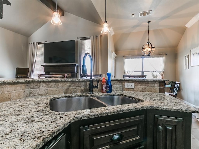 15508 Homecoming Dr, Edmond, OK 73013 - kitchen featuring a sink, light stone counters, healthy amount of natural light, and open floor plan