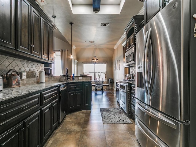 15508 Homecoming Dr, Edmond, OK 73013 - kitchen featuring stainless steel appliances, a sink, backsplash, light stone counters, and dark tile patterned floors