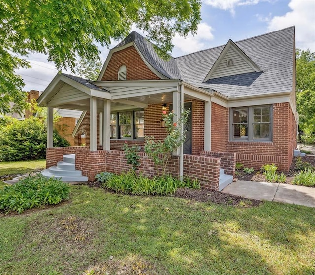 938 NE 21st St, Oklahoma City, OK 73105 - view of front of home featuring brick siding, a front lawn, and a shingled roof