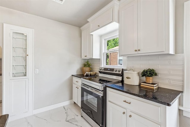 938 NE 21st St, Oklahoma City, OK 73105 - kitchen featuring stainless steel electric stove, baseboards, light marble finish floors, and backsplash