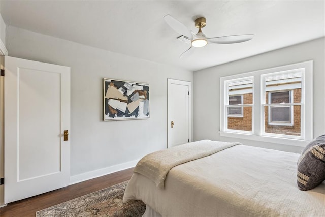 938 NE 21st St, Oklahoma City, OK 73105 - bedroom with dark wood-style floors, baseboards, and a ceiling fan