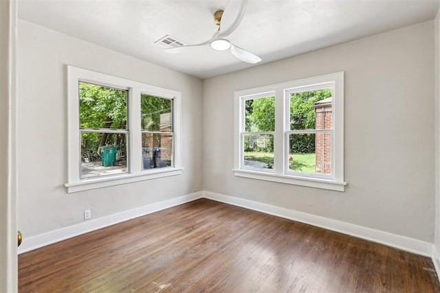 938 NE 21st St, Oklahoma City, OK 73105 - empty room with healthy amount of natural light, baseboards, and wood finished floors