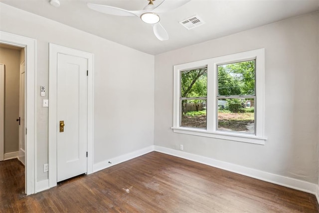 938 NE 21st St, Oklahoma City, OK 73105 - empty room featuring dark wood-style flooring, a ceiling fan, and baseboards
