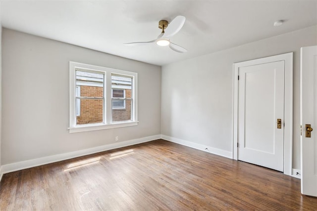 938 NE 21st St, Oklahoma City, OK 73105 - unfurnished room with wood finished floors, a ceiling fan, and baseboards