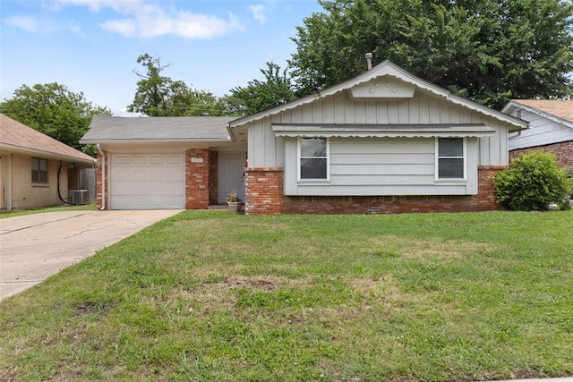 1221 NW 101st St, Oklahoma City, OK 73114 - ranch-style house featuring an attached garage, board and batten siding, driveway, brick siding, and a front lawn