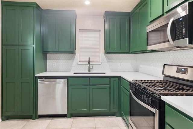 1221 NW 101st St, Oklahoma City, OK 73114 - kitchen featuring stainless steel appliances, a sink, light countertops, and tasteful backsplash
