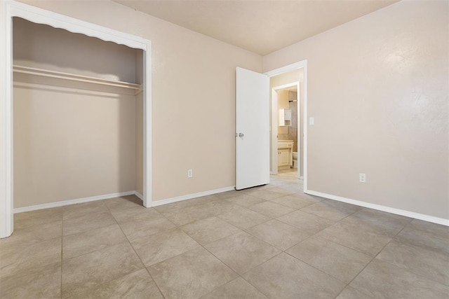 1221 NW 101st St, Oklahoma City, OK 73114 - unfurnished bedroom featuring a closet, baseboards, and light tile patterned flooring