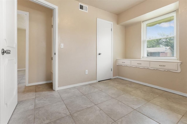 1221 NW 101st St, Oklahoma City, OK 73114 - spare room with light tile patterned floors and baseboards