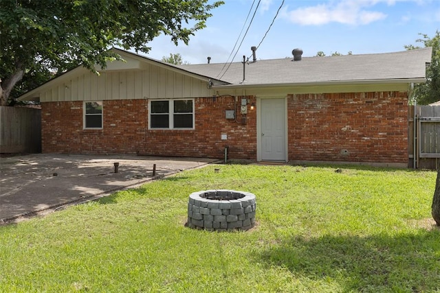 1221 NW 101st St, Oklahoma City, OK 73114 - back of property with an outdoor fire pit and brick siding