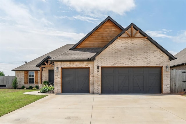 4442 Violet St, Tuttle, OK 73089 - view of front of home with an attached garage, brick siding, concrete driveway, and a shingled roof