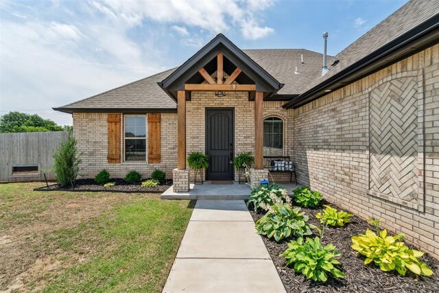 4442 Violet St, Tuttle, OK 73089 - entrance to property with brick siding and a shingled roof