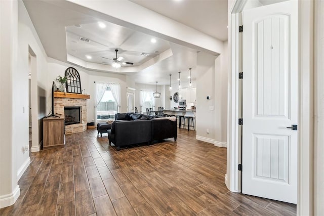 4442 Violet St, Tuttle, OK 73089 - living area featuring a tray ceiling, a ceiling fan, baseboards, dark wood-style flooring, and recessed lighting