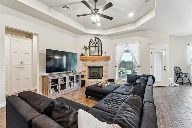 4442 Violet St, Tuttle, OK 73089 - living room featuring a ceiling fan, wood finished floors, a tray ceiling, baseboards, and recessed lighting