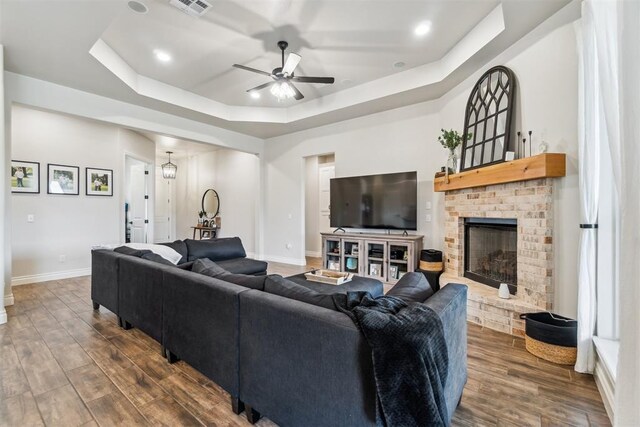 4442 Violet St, Tuttle, OK 73089 - living room featuring a ceiling fan, a raised ceiling, dark wood-style floors, baseboards, and recessed lighting