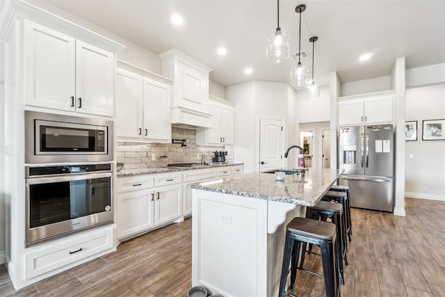 4442 Violet St, Tuttle, OK 73089 - kitchen featuring stainless steel appliances, a sink, backsplash, white cabinets, and recessed lighting