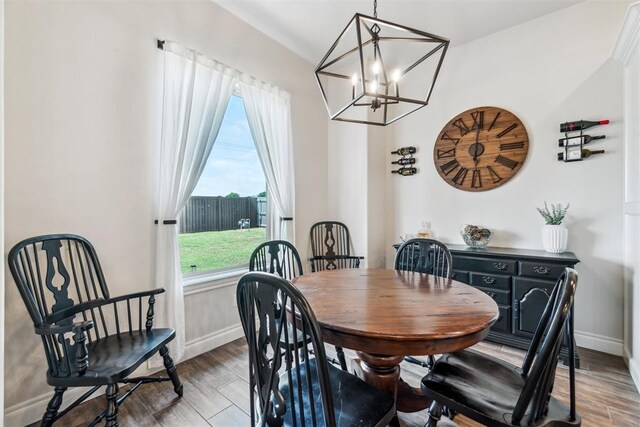 4442 Violet St, Tuttle, OK 73089 - dining room featuring a chandelier, baseboards, and wood finished floors