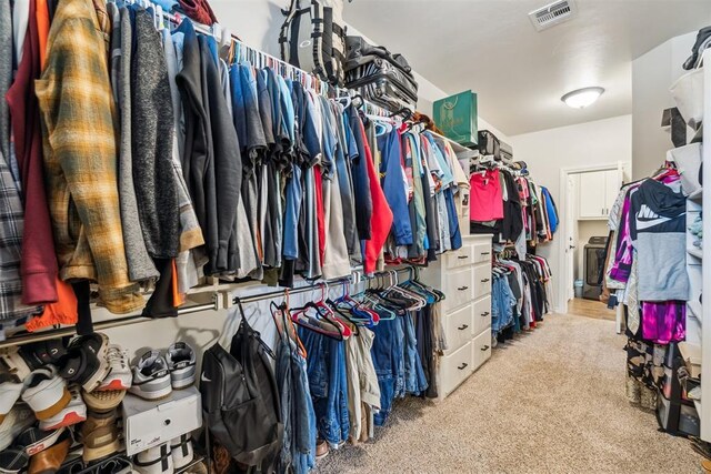 4442 Violet St, Tuttle, OK 73089 - walk in closet featuring light colored carpet