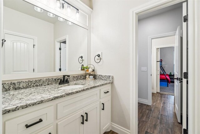 4442 Violet St, Tuttle, OK 73089 - bathroom featuring vanity, wood finished floors, and baseboards