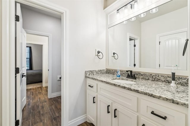 4442 Violet St, Tuttle, OK 73089 - bathroom with vanity, baseboards, and wood finished floors
