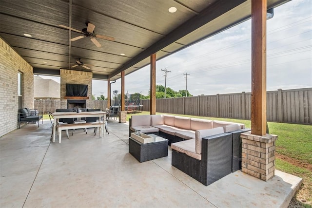 4442 Violet St, Tuttle, OK 73089 - fenced backyard featuring an outdoor living space with a fireplace, a patio area, a trampoline, and ceiling fan