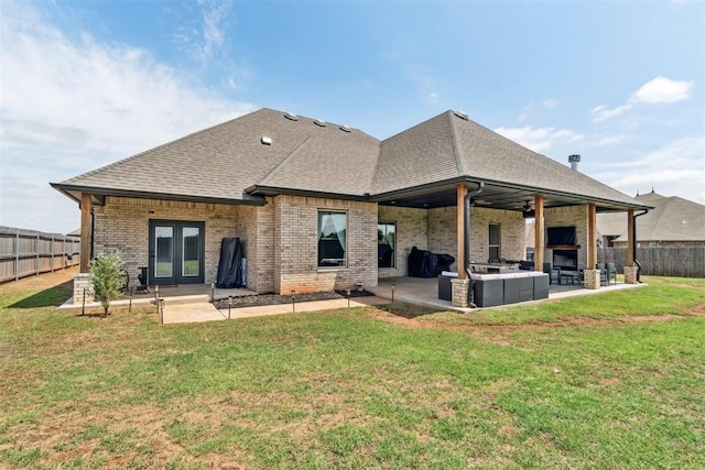4442 Violet St, Tuttle, OK 73089 - back of house with a patio area, brick siding, an outdoor living space with a fireplace, and a shingled roof
