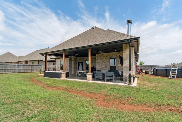 4442 Violet St, Tuttle, OK 73089 - back of house with an outdoor living space, ceiling fan, brick siding, a patio, and roof with shingles