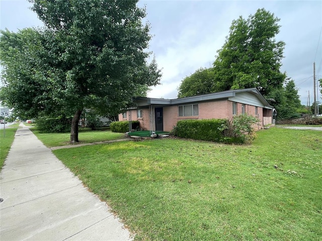 403 NW 3rd St, Minco, OK 73059 - view of front of house with brick siding and a front yard