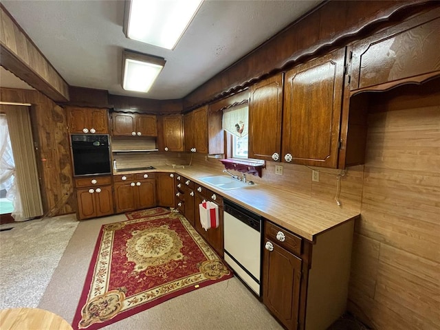 403 NW 3rd St, Minco, OK 73059 - kitchen featuring oven, white dishwasher, a sink, light countertops, and wood walls