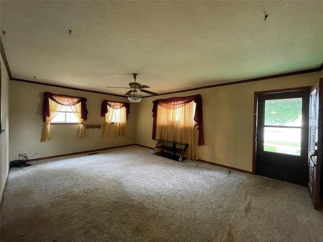 403 NW 3rd St, Minco, OK 73059 - unfurnished living room with crown molding, a textured ceiling, ceiling fan, carpet, and baseboards