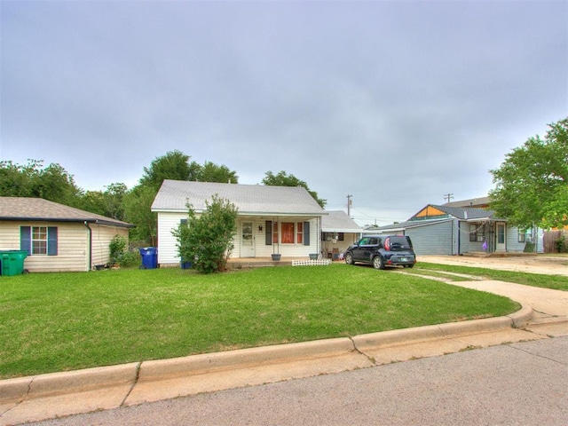 2133 SW 46th St, Oklahoma City, OK 73119 - view of front of house with covered porch, a front yard, and driveway
