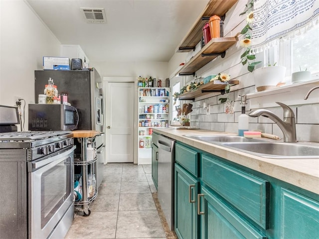 2133 SW 46th St, Oklahoma City, OK 73119 - kitchen featuring appliances with stainless steel finishes, open shelves, a sink, light countertops, and light tile patterned floors