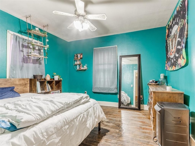 2133 SW 46th St, Oklahoma City, OK 73119 - bedroom with wood finished floors, heating unit, ceiling fan, and baseboards