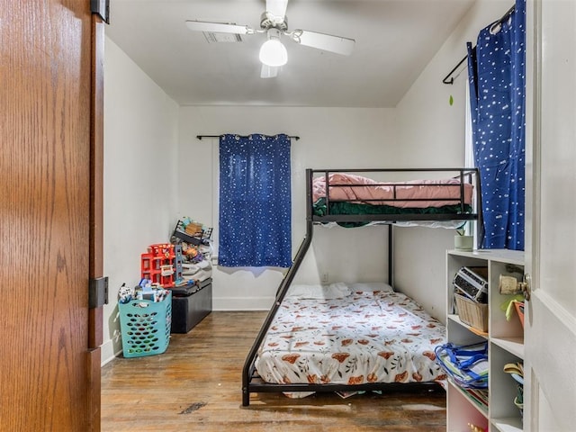 2133 SW 46th St, Oklahoma City, OK 73119 - bedroom featuring wood finished floors, ceiling fan, and baseboards