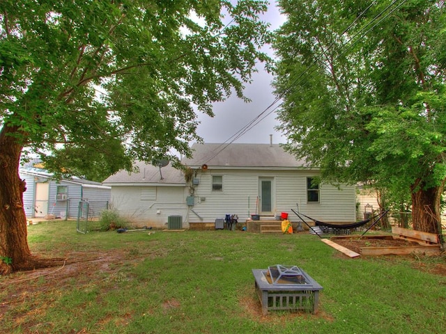 2133 SW 46th St, Oklahoma City, OK 73119 - back of property with central AC unit and an outdoor fire pit