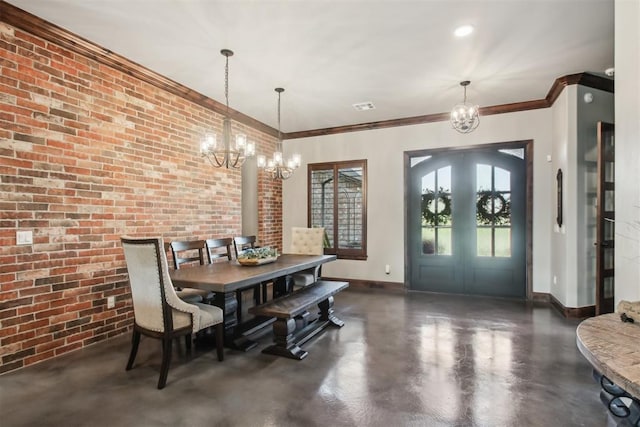 5813 Tiger Stone Dr, Mustang, OK 73064 - dining area featuring a chandelier, baseboards, finished concrete floors, brick wall, and ornamental molding