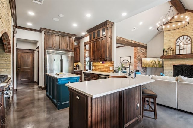 5813 Tiger Stone Dr, Mustang, OK 73064 - kitchen with concrete floors, stainless steel appliances, a kitchen island, light countertops, and a chandelier