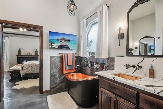5813 Tiger Stone Dr, Mustang, OK 73064 - ensuite bathroom featuring a freestanding tub, decorative backsplash, vanity, and concrete floors