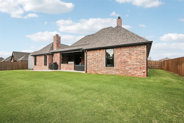 5813 Tiger Stone Dr, Mustang, OK 73064 - back of house featuring roof with shingles, a chimney, and brick siding