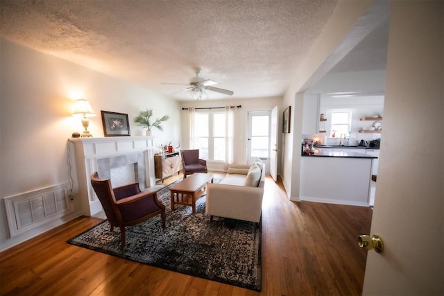 2616 NW 33rd St, Oklahoma City, OK 73112 - living room with a textured ceiling, wood finished floors, plenty of natural light, and ceiling fan