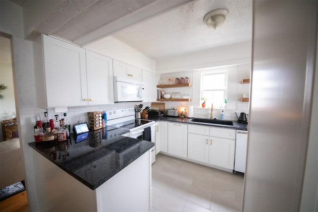 2616 NW 33rd St, Oklahoma City, OK 73112 - kitchen featuring a sink, white appliances, open shelves, backsplash, and a peninsula