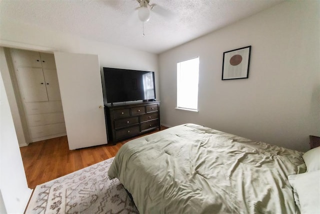 2616 NW 33rd St, Oklahoma City, OK 73112 - bedroom featuring wood finished floors, a textured ceiling, and ceiling fan