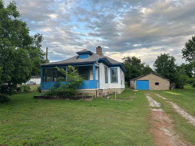 8312 Spencer Jones Rd, Jones, OK 73049 - view of property exterior featuring dirt driveway, a garage, an outbuilding, and a lawn