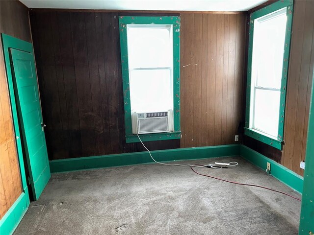 8312 Spencer Jones Rd, Jones, OK 73049 - unfurnished room featuring carpet floors, wooden walls, cooling unit, and baseboards