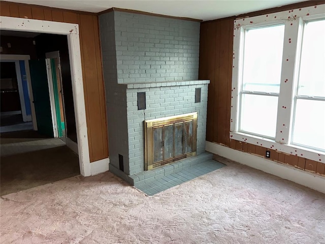 8312 Spencer Jones Rd, Jones, OK 73049 - unfurnished living room with healthy amount of natural light, carpet floors, a fireplace, and wooden walls