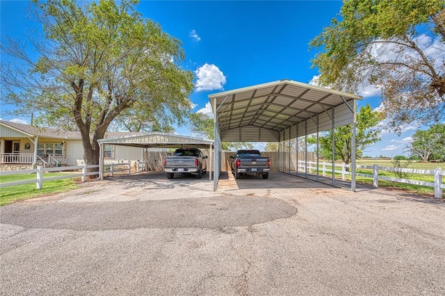 711 Sisson Ave, Sayre, OK 73662 - view of vehicle parking featuring asphalt driveway and a detached carport