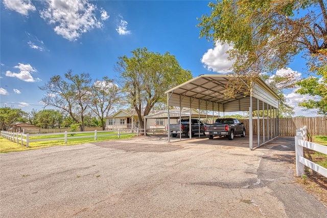 711 Sisson Ave, Sayre, OK 73662 - view of parking with asphalt driveway and a carport